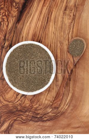 Bhringaraj kesharat herb powder ayurvedic alternative medicine over olive wood background. Eclipta alba. Used as a liver tonic and hair loss remedy and for premature graying.
