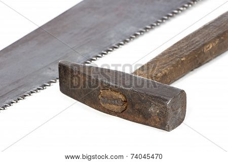 Photo of handsaw's teeth and hammer