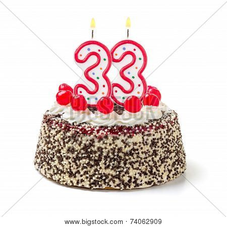 Birthday cake with burning candle number 33