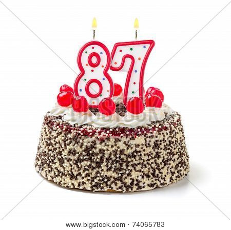 Birthday cake with burning candle number 87