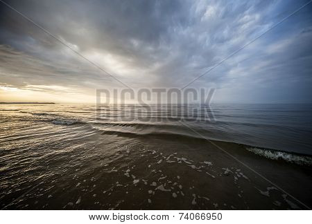 The calm Baltic Sea and colorful sunset Sky