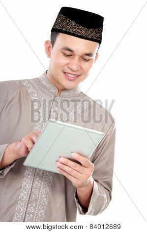 Young Muslim Man Playing On His Tablet