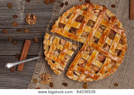 A Piece Of Sliced Apple Pie With A Metal Spatula On Vintage Wooden Background