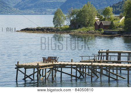 Chairs at the pier of a fjord in Balestrand Norway.