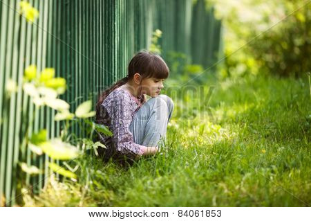 Sad Girl Sitting On The Grass