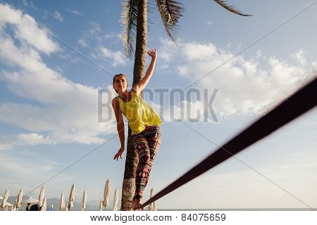 Teenage Girl  Balancing On Slackline With Sky View