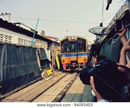 Train running through the railway station market , January 30,2015 in Bangkok,Thailand.