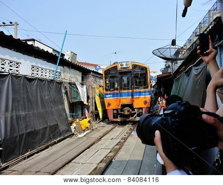 Train running through the railway station market , January 30,2015 in Bangkok,Thailand.