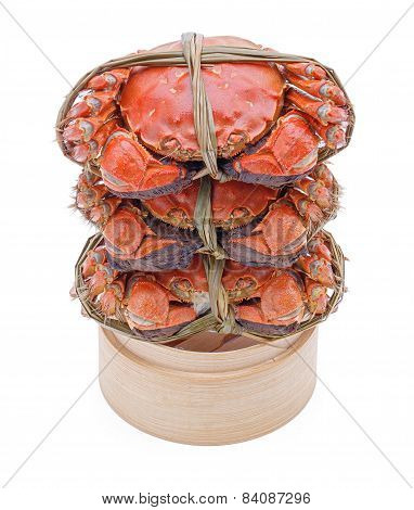 Hairy crabs on the Bamboo steamer Isolated in white background.