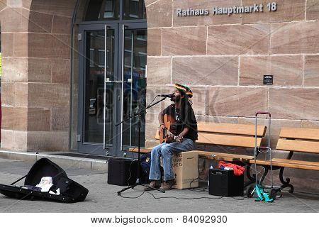 NURNBERG GERMANY - JULY 13 2014: Hauptmarkt the central square of Nuremberg - street musician singin