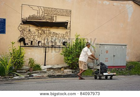 Malaysia, Penang, Georgetown - Circa Jul 2014: Artistic Sign Uses Cartoon Style Caricatures To Point