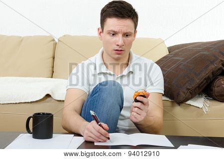 Young Man Taking Test And Counting Minutes Holding Watch