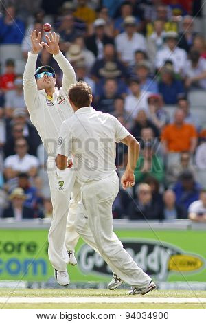 MANCHESTER, ENGLAND - August 03 2013: David Warner catches the ball as Ryan Harris looks on during day three of  the Investec Ashes 3rd test match at Old Trafford Cricket Ground