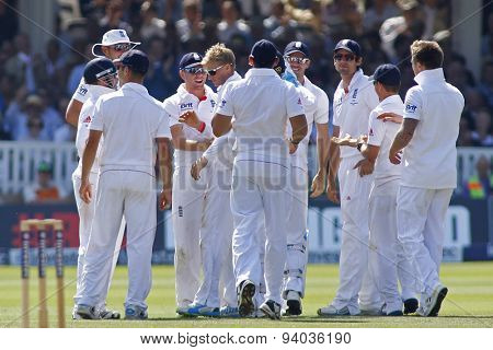 LONDON, ENGLAND - July 21 2013: Joe Root gets congratulated by his team mates after taking the wicket of Usman Khawaja during day four of the Investec Ashes 2nd test match, at Lords Cricket Ground