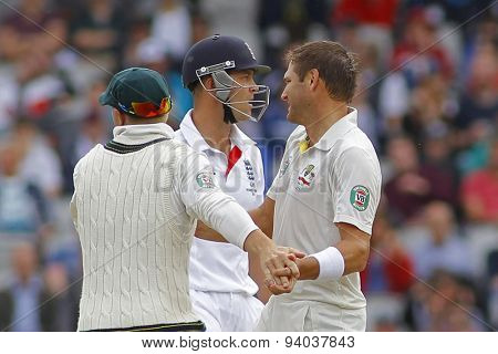 MANCHESTER, ENGLAND - August 05 2013: David Warner and Ryan Harris celebrates the wicket of Jonathan Trott during  the Investec Ashes 4th test match at Old Trafford Cricket Ground, on August 05, 2013