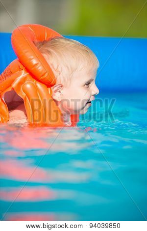 Pretty little boy in swimming pool