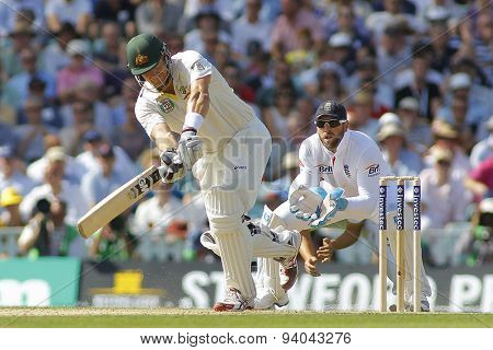 LONDON, ENGLAND - August 21 2013: Shane Watson hits the ball as Matt Prior watches on during day one of the 5th Investec Ashes cricket match between England and Australia
