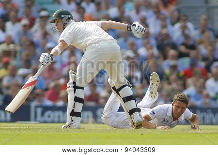 LONDON, ENGLAND - August 21 2013: Simon Kerrigan fielding of his own bowling as Steven Smith attempts to make his ground during day one of the 5th Ashes cricket match between England and Australia