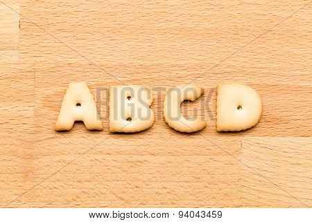 Letter ABCD cookie over the wooden background