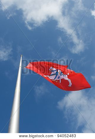 Old lithuanian flag in blue sky background