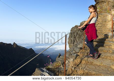 Young girl on the winding mountain trekking path at Pico do Areeiro, Madeira, Portugal