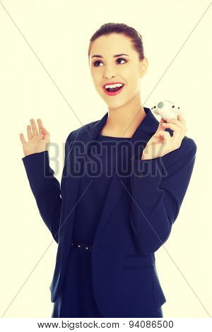 Young businesswoman with plane toy in hand