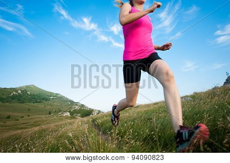 Beautiful Young Woman Runns Cross Country On A Mountian Path At Sunrise