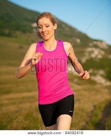 Beautiful Young Woman Runns Cross Country On A Mountian Path At Sunrise