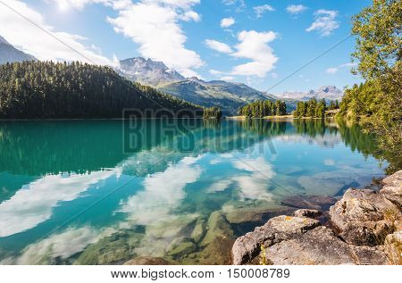 Great view of the azure pond Champfer in alpine valley. Popular tourist attraction. Picturesque and gorgeous scene. Location Swiss alps, Silvaplana village, district of Maloja, Europe. Beauty world.