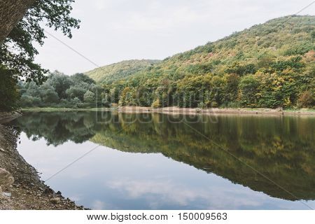 Wild Mountain Lake. Mountain Lake On The Background Of Autumn Forest