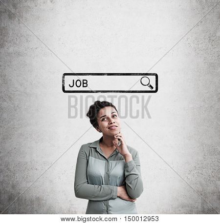 African American woman standing near concrete wall with search bar sketch and word job. Concept of job finding. Mock up