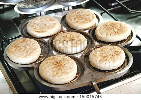 cooking Tigelle special pan Tigelliera traditional food Bologna Modena Emilia Romagna Italy