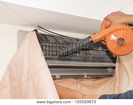 Single electrician man clean fix and maintain air conditioning in the house