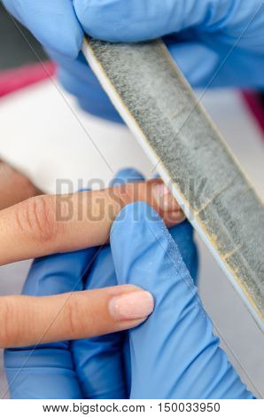 Woman In A Nail Salon Receiving A Manicure By A Beautician