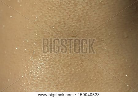 Wet skin human texture with water drops closeup background