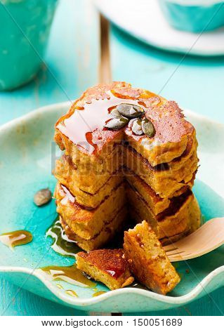 Pumpkin paleo pancakes on blue plate . selective focu