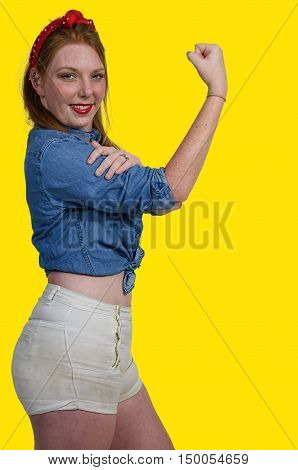 Beautiful woman dressed as the iconic Rosie the Riveter