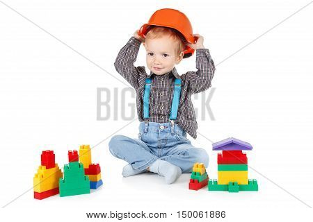 little boy in a red protective hardhat helmet isolated on white background