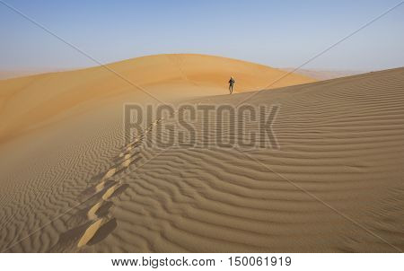 A person in Liwa desert that covers large area in Oman, UAE, KSA and Yemen