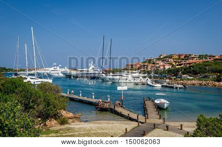 Yacht marina and small sand beach at Porto Cervo bay. Scenic views of Sardinia island, Italy