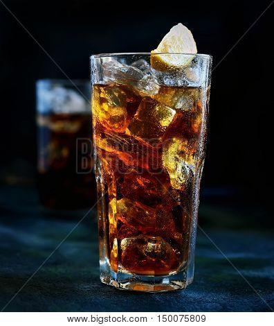 ced tea and lemon glass on a dark background