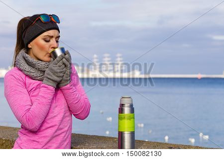Fit Woman In Cold Day Warming Up Drink Tea