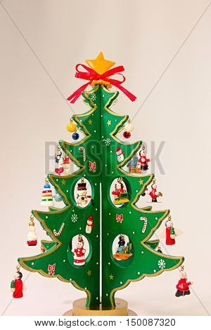 Cute Moe green wooden Christmas tree of red ribbon.