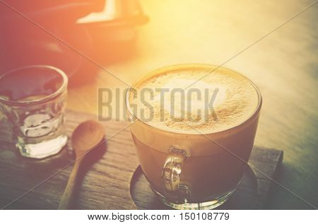 coffee cup on wood table with labtop office space