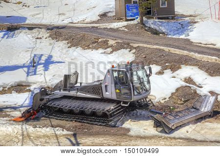 CAUCASUS RUSSIA - May 01.2015: Snow grooming on the shoulder of road on the of mount Everest