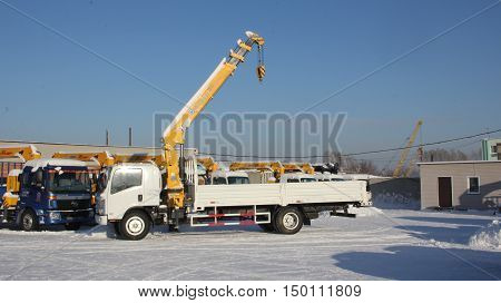 Great White Auto Truck Crane Standing On Construction Site In Winter - Russia, Crimea -january, 21,