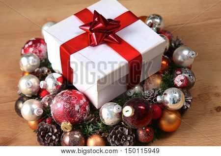 New Year gift on a golden tinsel background boly.