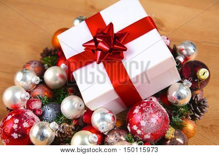 New Year gift on a golden tinsel background boly.