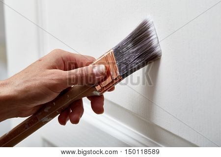 Hand with a paint brush.