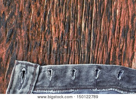 Vintage jeans sewing line of closeup texture.Old jeans texture on old wood.